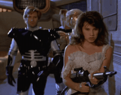 Woman In White Dress Holding Gun GIF