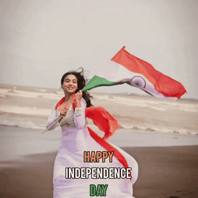 Woman In White Dress Holding Indian Flag On Beach GIF
