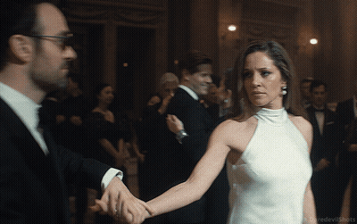 Woman In White Dress Holding Man's Hand GIF
