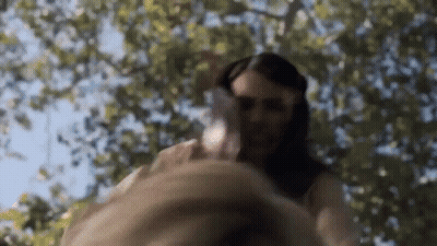 Woman In White Dress Holding Man's Hand Under Tree GIF