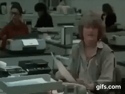 Woman In White Dress Holding Microphone In Front Of SNL Map GIF