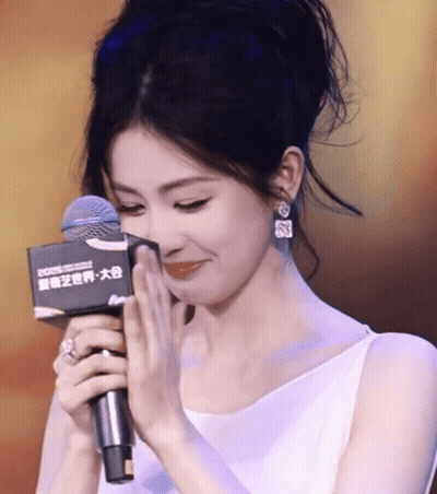 Woman In White Dress Holding Rode Microphone GIF