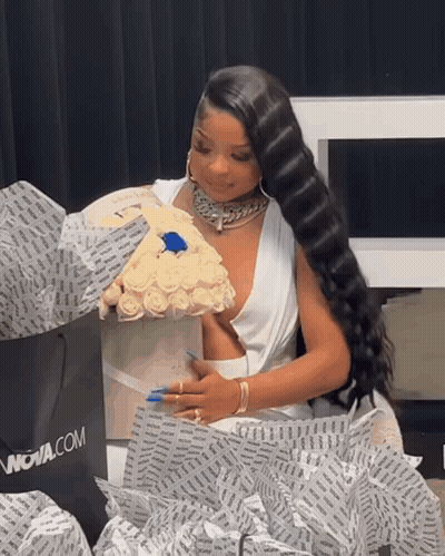 Woman In White Dress Holding Roses And Nova.com Bag GIF
