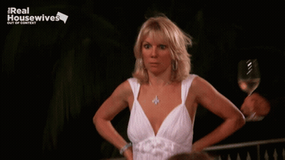 Woman In White Dress Holding Wine In Front Of Real Housewives Out Of Context Sign GIF