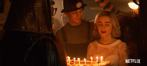 Woman In White Dress In Front Of Cake And Netflix Logo GIF