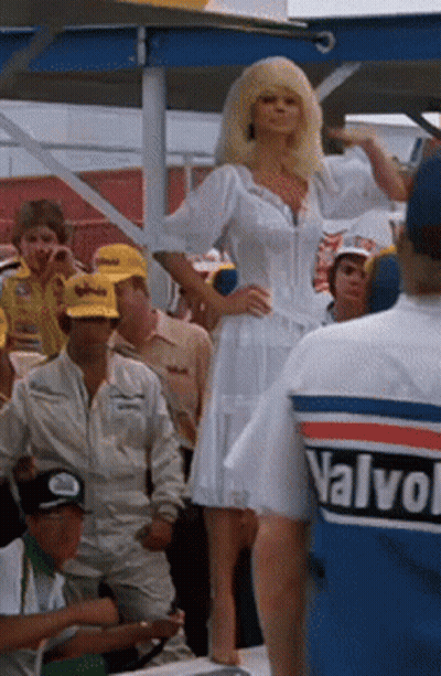 Woman In White Dress In Front Of Crowd Wearing Valvoline Shirt GIF