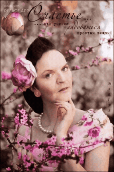 Woman In White Dress In Front Of Flower Wall GIF