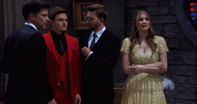 Woman In White Dress In Front Of Man In Suit GIF