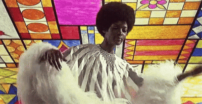 Woman In White Dress In Front Of Stained Glass Window GIF