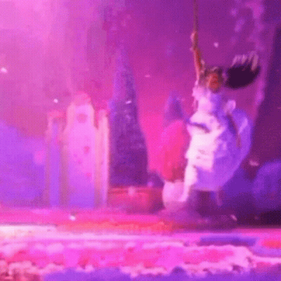Woman In White Dress Jumping Holding Purple Object GIF