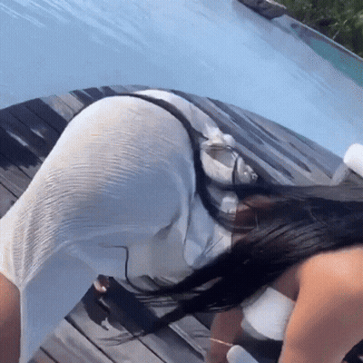 Woman In White Dress Kneeling By Pool GIF