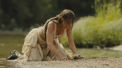 Woman In White Dress Kneeling By River GIF