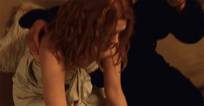 Woman In White Dress Laying On Floor With Man Holding Her Shoulder GIF
