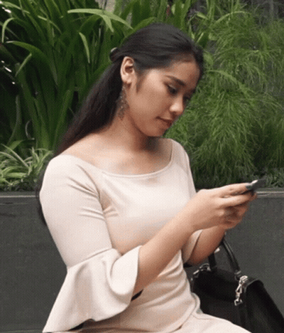 Woman In White Dress Looking At Phone GIF