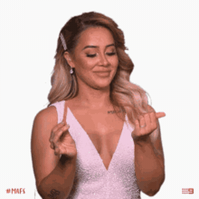Woman In White Dress Making Peace Sign GIF