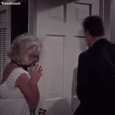 Woman In White Dress Next To Man In Black Suit GIF
