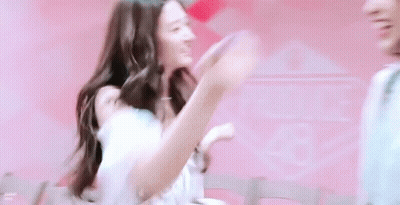 Woman In White Dress Next To Man In Pink Shirt GIF