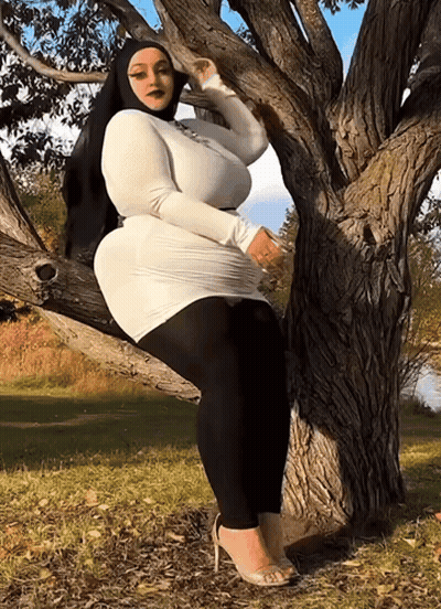 Woman In White Dress On Tree Branch GIF