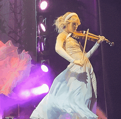 Woman in White Dress Playing Violin on Stage