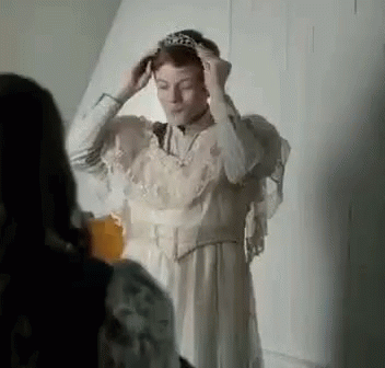 Woman In White Dress Putting On Tiara GIF
