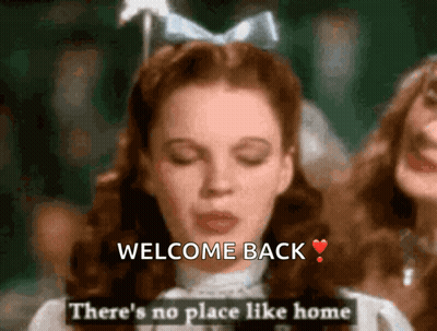 Woman In White Dress Saying Welcome Back GIF