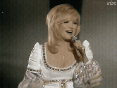 Woman In White Dress Singing Into Microphone GIF