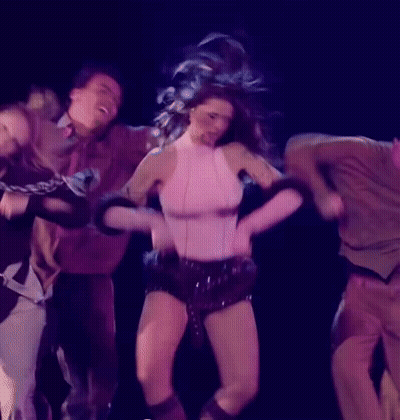 Woman In White Dress Singing On Stage With Dancers Gaban GIF