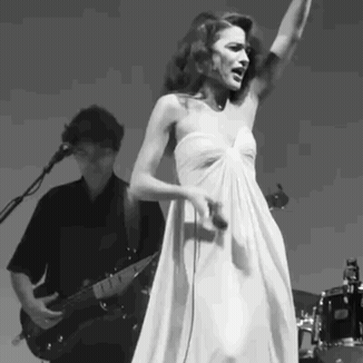 Woman In White Dress Singing While Man Plays Guitar GIF