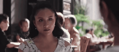 Woman In White Dress Sitting At Restaurant Table GIF