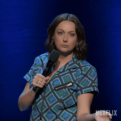 Woman In White Dress Sitting In Front Of Olay Shelf GIF