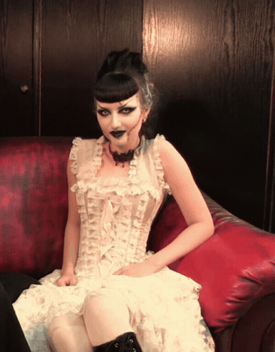 Woman In White Dress Sitting On Couch GIF
