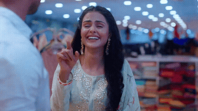 Woman In White Dress Smiling And Pointing At Man GIF