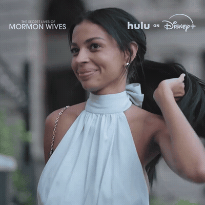 Woman In White Dress Smiling For Secret Lives Of Mormon Wives On Hulu GIF