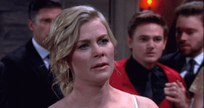 Woman In White Dress Standing Before Men GIF