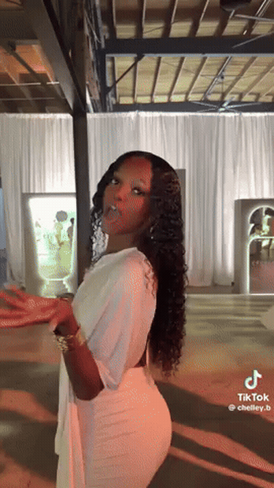 Woman In White Dress Standing By White Curtain GIF