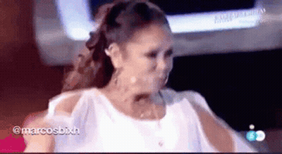 Woman In White Dress Standing In Front Of TV GIF