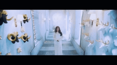 Woman In White Dress Standing In Hallway GIF