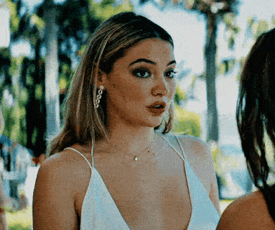 Woman In White Dress Standing Next To Woman GIF