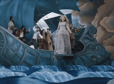 Woman In White Dress Standing On Boat In Ocean GIF