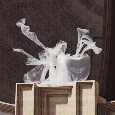 Woman In White Dress Standing On Pillar GIF