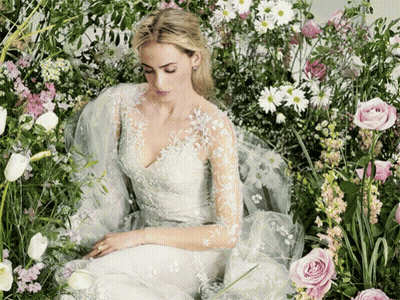 Woman In White Dress Surrounded By Flowers GIF