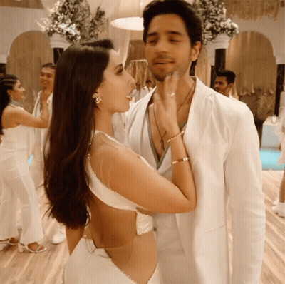 Woman In White Dress Touching Man's Face GIF
