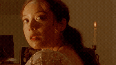 Woman In White Dress Tying Ribbon In Hair GIF