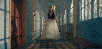 Woman In White Dress Walking Checkered Floor Hallway GIF