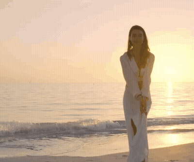 Woman In White Dress Walking On Beach GIF