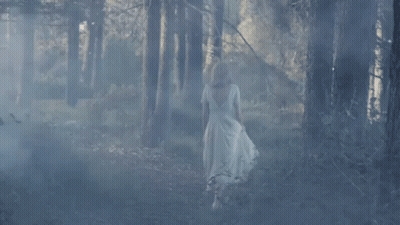 Woman In White Dress Walking Through Forest GIF