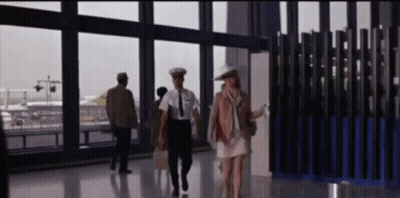 Woman In White Dress Walking With Man In Uniform GIF
