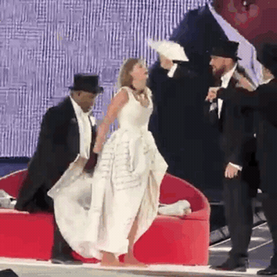 Woman In White Dress With Tuxedo Men And Hats GIF