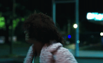 Woman In White Fur Coat Walking Down Street GIF