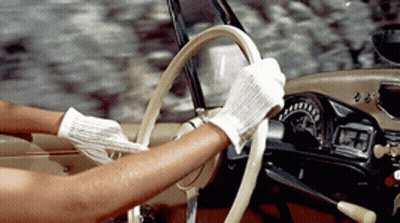 Woman In White Gloves Holding Steering Wheel GIF